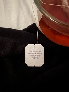 a glass bowl filled with liquid sitting on top of a black cloth covered tablecloth