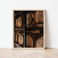 several wooden barrels stacked on top of each other in a room with wood flooring