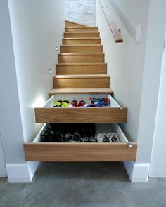 some shoes are sitting under the stairs