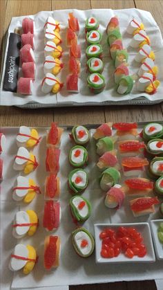 two trays filled with different types of sushi