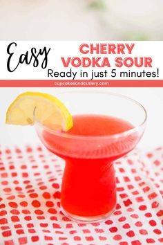 an easy cherry vodka sour recipe in a small glass with a lemon slice on the rim