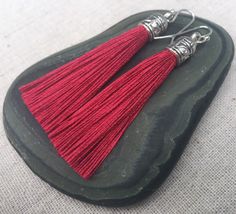 "Chic dark red tassel earrings! They would add a pop of color to any outfit for any occasion. Dress them up or down. They are timeless and versatile. They are lightweight, fun and unique! The tassels measure 2 1/8\" long by 1/4\" wide. They hang from simple silver ear wire hooks. Overall drop length is about 2 1/4\". Metal is allergy free plated silver. These are my latest creation! I have them available in many colors! Find them all under the category tassel earrings in my shop. Thanks for stop Red Dangle Tassel Earrings As Gift, Red Tassel Earrings For Gift, Red Dangle Tassel Earrings For Gift, Red Tassel Drop Earrings Gift, Red Tassel Earrings With Latkans For Gifts, Red Tassel Earrings With Latkans As Gift, Red Latkans Tassel Earrings For Gifts, Red Tassel Drop Earrings For Pierced Ears, Maroon Earrings