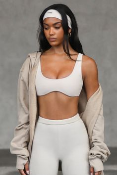 Front view of model posing in the stretchy and sculpting sueded yuma contour bra with a deep scoop neckline and curved hem Chic Crop Top With Built-in Bra And Minimal Stretch, Low-cut Crop Top With Built-in Bra For Loungewear, Solid Color Bra-friendly Low-cut Tank Top, Wide Straps Seamless Crop Top For Casual Wear, Chic Seamless Low-cut Tank Top, Fitted Low-cut Sports Bra For Loungewear, Low-cut Fitted Sports Bra For Loungewear, Fitted Scoop Neck Bra For Loungewear, Low-cut Sports Bra For Loungewear