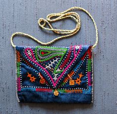 "Rabari hand embroidery, cotton on mashru (rayon-cotton) Go lightly with a dash of pizzaz.  Sajnuben hand embroidered an accent just right for your bare necessities on an evening out. 5.5\" x 7.5\" - midnight blue background" Festive Multicolor Embroidered Rectangular Shoulder Bag, Traditional Embroidered Cotton Shoulder Bag, Festive Rectangular Shoulder Bag With Motifs, Multicolor Embroidered Rectangular Shoulder Bag, Rectangular Embroidered Shoulder Bag For Festivals, Embroidered Rectangular Shoulder Bag For Festivals, Rectangular Shoulder Bag With Multicolor Embroidery, Blue Rectangular Shoulder Bag For Festivals, Everyday Rectangular Shoulder Bag With Motifs