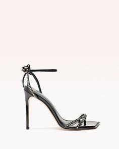 The Skye sandal translates timeless allure. The delicate square toe lends an air of sophistication to the design while the upper showcases lines of crystals, creating a mesmerizing interplay of light and sparkle. The back of the sandal features delicate and slender straps that elegantly frames the feet.  Material: Vern Luxury Square Toe Evening Heels, Luxury Square Toe Heels For Night Out, Luxury Square Toe Heels For Evening, Designer Square Toe Evening Sandals, Designer Evening Sandals With Square Toe, Glamorous Evening Sandals With Square Toe, Luxury Square Toe Heels For Cocktail, Build Wardrobe, Square Toe Heels