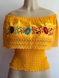 100% Authentic Mexican Shirt This Shirt is gorgeous. Material: 85% cotton 15% acrilic Color: yellow Size:One size fit most  This blouse is with elastic an the waist  Ebroidery Mexican shirt Please take a good look an the picture to see if this is the color your looking for. Folk Fabric Flowers Mexican Tunic Traditional Embroidery This shirt is perfect for any occasion This Shirt is meant to provide extreme comfort throughout the day Fitted Off-shoulder Yellow Tops, Yellow Fitted Off-shoulder Tops, Cotton Tops For Fiesta, Cotton Off-shoulder Tops With Floral Embroidery, Off-shoulder Cotton Top With Floral Embroidery, Cotton Embroidered Off-shoulder Tops, Embroidered Off-shoulder Cotton Tops, Yellow Embroidered Tops For Festival, Yellow Embroidered Festival Tops