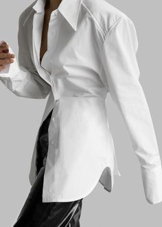 Color: White Lightweight cotton woven fabric Oversized silhouette Pointed collar Lightly padded shoulders Curved hem Adjustable fabric ties on sides Button cuffs Concealed front button closure Unlined 100% Cotton Dry Clean Imported White Long Sleeve Blouse With Hidden Button Closure, White Blouse With Hidden Button Closure For Work, Chic White Blouse For Business, White Shirt With Hidden Button Closure For Spring, Chic White Business Shirt, Chic White Shirt With Lapel Collar, White Button-up Blouse With Hidden Closure, White Button-up Blouse With Hidden Buttons, White Business Blouse For Spring