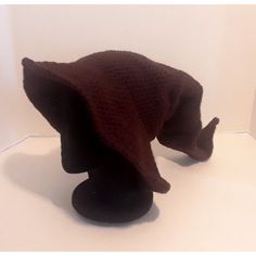 a brown hat is on display in a white room