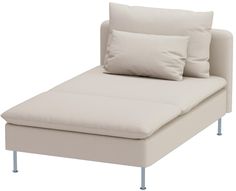 a white couch with two pillows on it and some metal legs in front of it