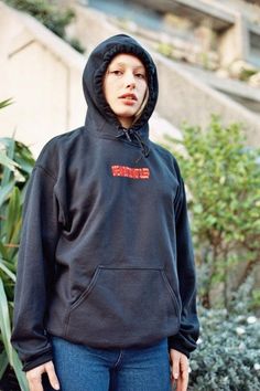 a woman in a black hoodie standing in front of a bush Embroidered Red Hoodie For Streetwear, Red Embroidered Hoodie For Streetwear, Sporty Embroidered Hoodie For Streetwear, Embroidered Black Hoodie For Streetwear, Black Embroidered Hoodie For Streetwear, Red Hoodie With Embroidered Logo For Streetwear, Sleep Embroidery, Stylish Lifestyle, Winter Dress Outfits