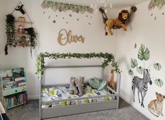 a child's bedroom decorated with jungle animals