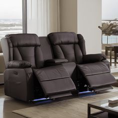 a living room with two recliners and a table in front of the window