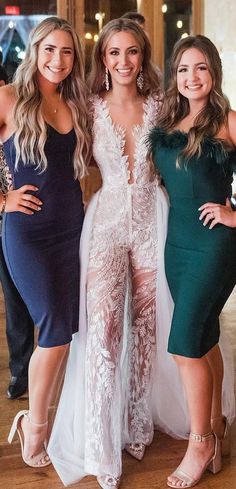 three women in dresses posing for the camera