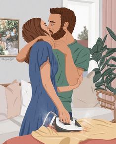 a man and woman are kissing while ironing clothes on a bed in the living room