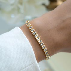 Super chic, emerald cut bezel set tennis bracelet featuring cubic zirconia stones. Looks absolutely gorgeous and high-end! Handmade with love, care and attention to detail! - - D E T A I L S - -  ▪︎ We use a Thick plating of 14k Gold or Rhodium over Brass  ▪︎ Available in Sizes: 6.25", 6.75" or 7"  ▪︎ Latch Closure ▪︎ Nickel-free, lead free and hypoallergenic ▪︎ Highest Grade CZ for an authentic diamond look! Unsure of your bracelet length? Use our Bracelet Sizer Tool! https://samijewels.etsy.com/listing/1782950827 Bracelets on Model 🎁 Comes in a gift-box, ready for gift giving!  ✈️ Ships same day for fast delivery!  ♡ Made with 100% Pure Love!  🥰 Happy to answer any questions you may have!  🤗 Let's Connect!  IG: samijewels_ Cubic Zirconia Channel Set Tennis Bracelet As Gift, Channel Set Cubic Zirconia Tennis Bracelet As A Gift, Elegant Wedding Tennis Bracelet With Channel Set, Diamond Bracelet With Handset Stones For Anniversary, Elegant Channel Set Tennis Bracelet For Weddings, Cubic Zirconia Channel Set Tennis Bracelet For Wedding, Wedding Bracelets With Channel Set Cubic Zirconia, Wedding Cubic Zirconia Diamond Bracelet With Bezel Setting, Formal Cubic Zirconia Tennis Bracelet With Handset Stones