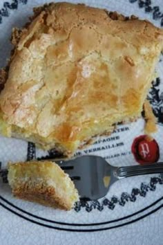 a piece of pie sitting on top of a white and black plate