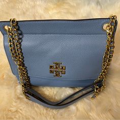 Tory Burch Britten Medium Flap Chain Shoulder Handbag Brand New ! 100% Authentic! Features: Inner Slip And Zip Pocket Outer Slip Pocket Chain Accented Shoulder Color: Blue Material: Pebbled Leather Measures: 10.5w X 8.25" H X 3.75" D Msrp: $458.00 Beautiful Color,Brand New,No Tags. Elegant Blue Shoulder Bag With Metal Hardware, Blue Tote Shoulder Bag With Chain Strap, Blue Shoulder Bag With Chain Strap For Shopping, Chic Tan Shoulder Bag With Chain Strap, Blue Tote Shoulder Bag With Metal Hardware, Blue Top Handle Shoulder Bag With Chain Strap, Chic Blue Bags With Metal Hardware, Blue Shoulder Bag With Top Handle And Chain Strap, Tan Travel Bag With Chain Strap