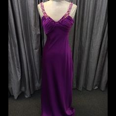 Plum Faviana Gown, Satin Fabric, Low Back Elegant Purple V-neck Gown, Fitted Purple Gown With Pleated Bodice, Elegant Purple Maxi Dress For Prom, Elegant Purple Gown For Evening, Purple Gown With Ruched Bodice For Party, Elegant Purple Dress With Ruched Bodice, Purple Evening Dress For Formal Occasions, Elegant Purple Spring Gown, Elegant Purple Gown For Prom Season