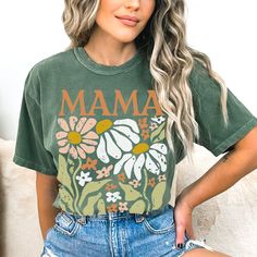 Introducing our beautiful "Boho Flower Mom" T-shirt, a delightful blend of floral elegance and heartfelt love, making it the perfect gift for all the amazing moms out there! Product Features: Exquisite Floral Design: Our Flower Shirt boasts a stunning and intricate floral graphic that celebrates the beauty of wildflowers. The vibrant colors and delicate details capture the essence of nature's most enchanting blooms. Aesthetic Appeal: This Floral Graphic Tee is not just a T-shirt; it's a wearable Hippie Multicolor T-shirt For Spring, Green Tops With Vintage Print For Summer, Green Vintage Print Short Sleeve Top, Green Vintage Print Tops For Summer, Green Bohemian T-shirt For Summer, Spring Vintage Print Top With Short Sleeves, Green Top With Vintage Print For Summer, Spring Top With Vintage Print And Short Sleeves, Green Short Sleeve Tops With Plant Print