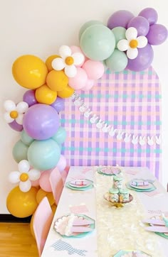 a table with balloons and plates on it