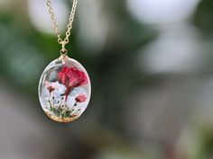 This necklace features a rose, the birth flower for June, carefully preserved in a clear resin pendant. The rose symbolizes love, royalty, beauty, sensuality, secrecy, and mysticism, making this necklace a perfect personalized birthday gift. Material: 14k gold filled chain and components, Resin Flower: Real Pressed Flower Chain Length: 16" (40cm) , 18" (45cm)  Pendant Width: 0.79" (2cm) Pendant Height: 0.98" (2.5cm) Every pieces is made by hand and unique, therefore each piece might be slightly different. Comes packed with a gift bag or box. This is a handmade product, there is a tiny possibility of imperfections and micro bubbles. Rose Birth Flower Jewelry Gift, Rose Birth Flower Jewelry For Gifts, Rose Flower Charm Necklace For Gift, Rose Jewelry With Pressed Flowers For Gifts, Pink Birth Flower Necklace For Anniversary, Gift Clear Jewelry With Flower Charm, Clear Flower Pendant Necklace As Gift, Rose Flower Necklace As Gift, Rose Flower Necklace For Gift