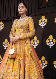 Pakistani Bridal Yellow Orange Lehenga Choli is a traditional masterpiece to wear on any wedding festivity, especially Mehndi or Mayun. The vibrant shade of this Lehenga Choli makes it an alluring choice for the Bride. Hand-crafted adornments and designs make this Mehndi Dress an epitome of beauty and royalty. Choli: Bridal choli in the bright yellow shade is gracefully emblazoned with hand-crafted details of sitara and pearls. The fully embellished choli is adorned with lavish designs and fine Anarkali Style Sharara With Multicolor Embroidery For Wedding, Wedding Gown With Multicolor Embroidery And Zari Work, Multicolor Anarkali Traditional Wear For Wedding, Bollywood Style Gown With Multicolor Embroidery For Wedding, Traditional Gown With Multicolor Embroidery For Reception, Multicolor Embroidered Gown With Dupatta For Wedding, Semi-stitched Multicolor Embroidered Wedding Gown, Bollywood Style Wedding Gown With Multicolor Embroidery, Multicolor Embroidered Semi-stitched Wedding Gown