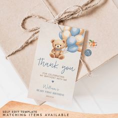 a brown teddy bear sitting on top of a gift box with a thank you tag attached to it