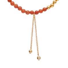 The Negroni necklace from our Aperitivo Collection is both strong and sweet, featuring a drop chain with handcrafted gold-plated beads to add extra flair to your layered necklace look. Crafted with tangerine semi-precious stone beads with intermittent 24K gold-plated brass beads, this tasteful necklace is sure to shine. Measurements: 16 " long, 2 " extension, 3 1/4" drop-down pendant. Materials: Semi-precious stone, 24K gold-plated brass. All Ben-Amun jewelry is handcrafted and made to order in Elegant Carnelian Necklaces In Yellow Gold, Elegant Yellow Gold Carnelian Necklace, Elegant Gold Carnelian Beaded Necklaces, Elegant Gold Carnelian Beaded Necklace, Gold Beaded Necklaces With Gemstone Dangle, Gold Dangle Beaded Necklace With Gemstone Beads, Gold Lariat Necklaces With Gemstone Beads, Gold Dangle Beaded Necklace With Gemstones, Gold Lariat Necklace With Gemstone Beads