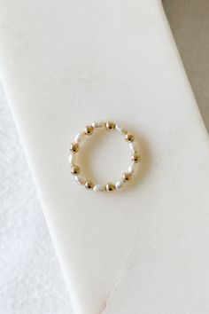 14k gold filled stretchy beaded ring with 14k gold filled 2.5mm beads and freshwater pearls Please note: since this ring is stretchy, it can fit a half size larger! Diy Pearl Rings, Homemade Rings, Ideas Pulseras, Tiny Bead Bracelet, Stretchy Rings, Bead Rings, Pearls Diy, Nice Nails, Tiny Rings