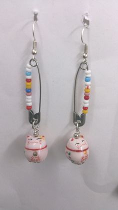 the earrings are decorated with beads and charms