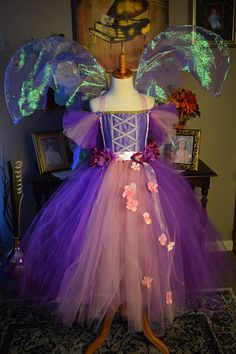 a dress made out of tulle with flowers on it