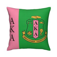 a green and pink pillow with the words aka on it