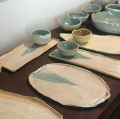 a table topped with plates and bowls filled with watercolor paint on them, sitting next to each other