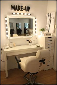 a chair that is sitting in front of a desk with a mirror and lights on it