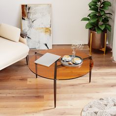 a living room with a couch, coffee table and potted plant