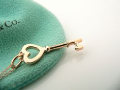 Offered for sale is a classic and very pretty Tiffany and Co. 18K Rose Gold Heart Key Charm Necklace. Wonderful necklace that fits a lifestyle on the go -- the necklace can be worn to almost any occasion! Hanging from its beautiful Tiffany & Co. 18K Rose Gold curb chain is a super pretty 18K Rose Gold Heart Key charm. It is simple and yet looks extremely elegant. Imagine the piece with your professional office attire ... Now imagine it with jeans or weekend wear ... Perfect in every way! The Key Charm Necklace, Gold Curb Chain, Professional Office, Heart Key, Rose Gold Heart, Heart And Key, Key Necklace, Tiffany And Co, Office Attire