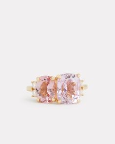 two stone ring set in yellow gold and pink topazte, with diamonds on each side