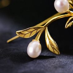 Elevate your elegance with these exquisite silver 18K Gold-Plated Leaf and Pearl Earrings. These stunning earrings feature intricately designed gold-plated leaves that shimmer with a delicate, natural beauty. Adorned with lustrous pearls, they are perfect for any occasion. These earrings effortlessly blend nature-inspired elements with classic glamour, making them a must-have addition to your jewelry collection. Whether you're dressing up for a special event or adding a touch of luxury to your e Silver Wire Earrings, Natural Pearl Earrings, Olive Leaves, Studded Necklace, Olive Leaf, Pearl Earrings Dangle, Threader Earrings, Delicate Earrings, Wire Earrings