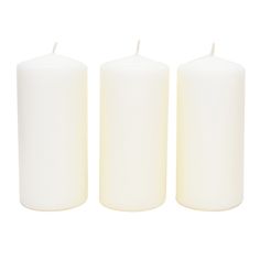 three white candles sitting next to each other