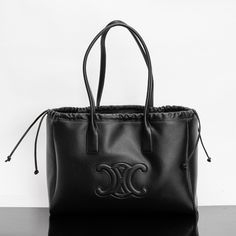 CABAS TRIOMPHE Smooth Cow Leather Tote Drawstring Bag  17 X 11 X 7 inches (44 X 28 X 18 cm)  Cow leather  Suede cowhide lining  shoulder  Decorative drawstring  1 main compartment  Internal flat pocket  Leather handles are 11 inches (27 cm) long Celine Cabas, Lv Purse, Celine Handbags, Lv Handbags, Black Leather Handbags, Lv Belt, Mark Lee