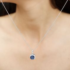 Product Details Surprise your significant other with a graceful gift: the Created Blue Sapphire Pendant Necklace. This elegant piece of fine jewelry features a Cushion Cut Created Blue Sapphire at its center, surrounded by a halo of Round Cut Zircon Stones. The halo pendant is crafted from Solid Gold, adding to its sophistication. This Classic Pendant Necklace is a timeless addition to any womans jewelry collection. Product Information SKU SHP-PENDANT082020001 Length 18.2 mm Width 11.4 mm Weight Classic Pendant Necklace, Sapphire Pendant Necklace, Blue Sapphire Pendant, Sapphire Necklace Pendants, Halo Pendant, Sapphire Pendant, Statement Pendant, Cushion Cut, Blue Sapphire