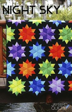 a colorful quilt with stars on it and the words night sky