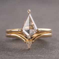 two gold wedding rings with a white diamond