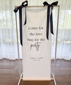 a white banner with black ribbon hanging from it