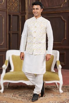 Look your best at any festive occasion with this stunning pain white jacket style men's kurta with churidar. Made from cotton art silk fabric, that adds to its traditional appeal. The Chinese collar and full sleeves offer a stylish touch, while the bottom made of art silk fabric completes the look. The jacket is adorned with intricate resham thread, sequins, and printed work. Designed to fit a wide range of body types, this jacket style men's kurta with churidar can be customized up to a maximum size of 46 inches. Cream Groomsmen, Kurta Pajama With Nehru Jacket, Plain Kurta, Velvet Suit Design, Anarkali Suits Bollywood, Frock Style, Men's Kurta, Bollywood Dress, Purple Saree