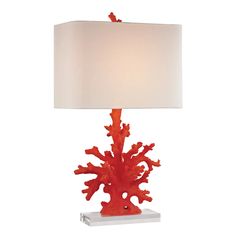 a red coral lamp with a white shade