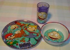 three cartoon plates and two cups on a table