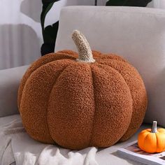 a large pumpkin sitting on top of a white couch