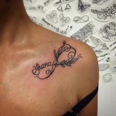 the back of a woman's shoulder with a name tattoo on it