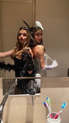 two women dressed up in costumes taking a selfie